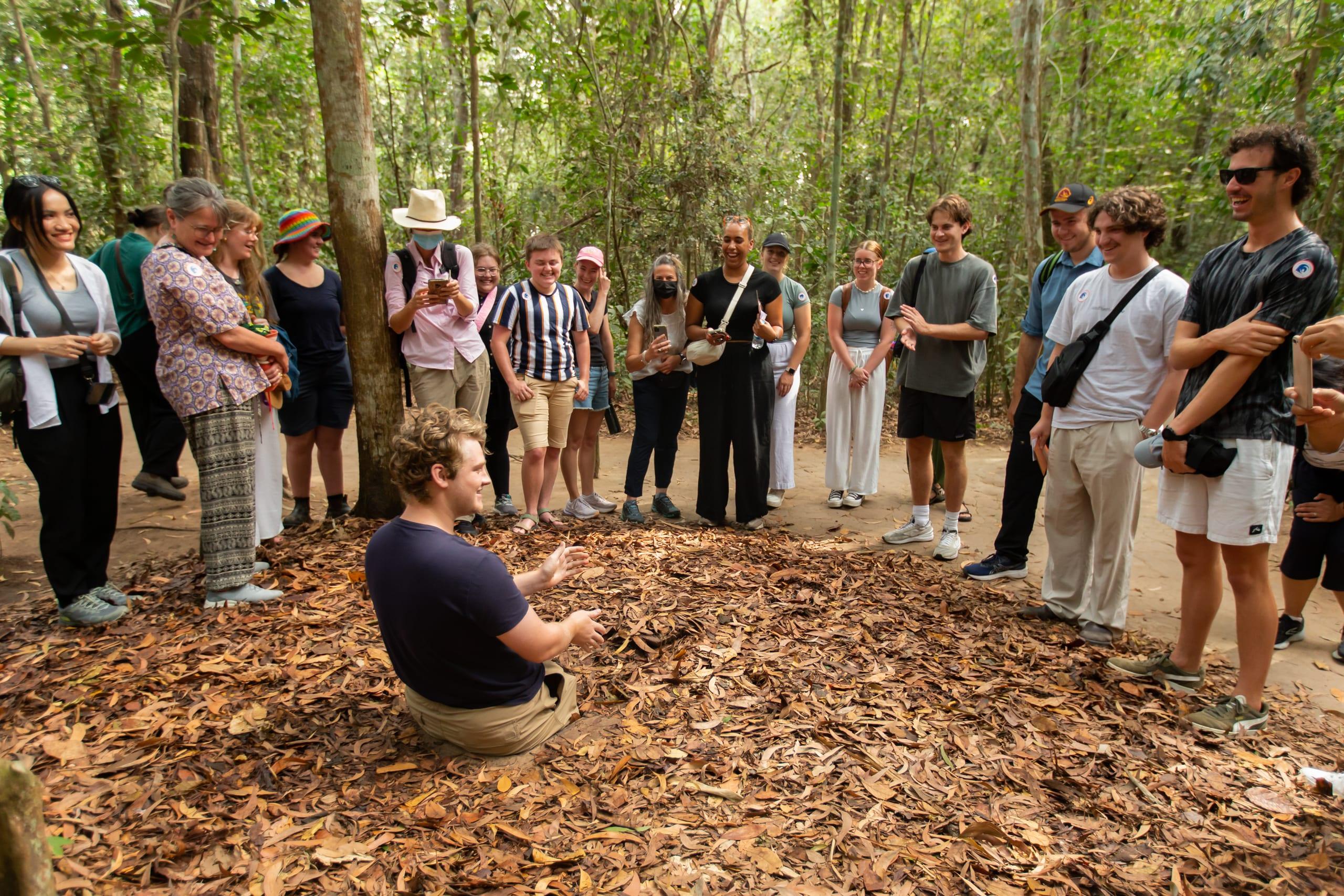 Viaggiatori che ascoltano una guida nella foresta